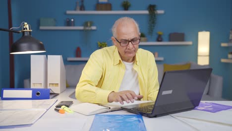 Home-office-worker-old-man-smiling-at-camera.